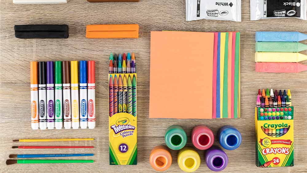 Table filled with various Crayola products.